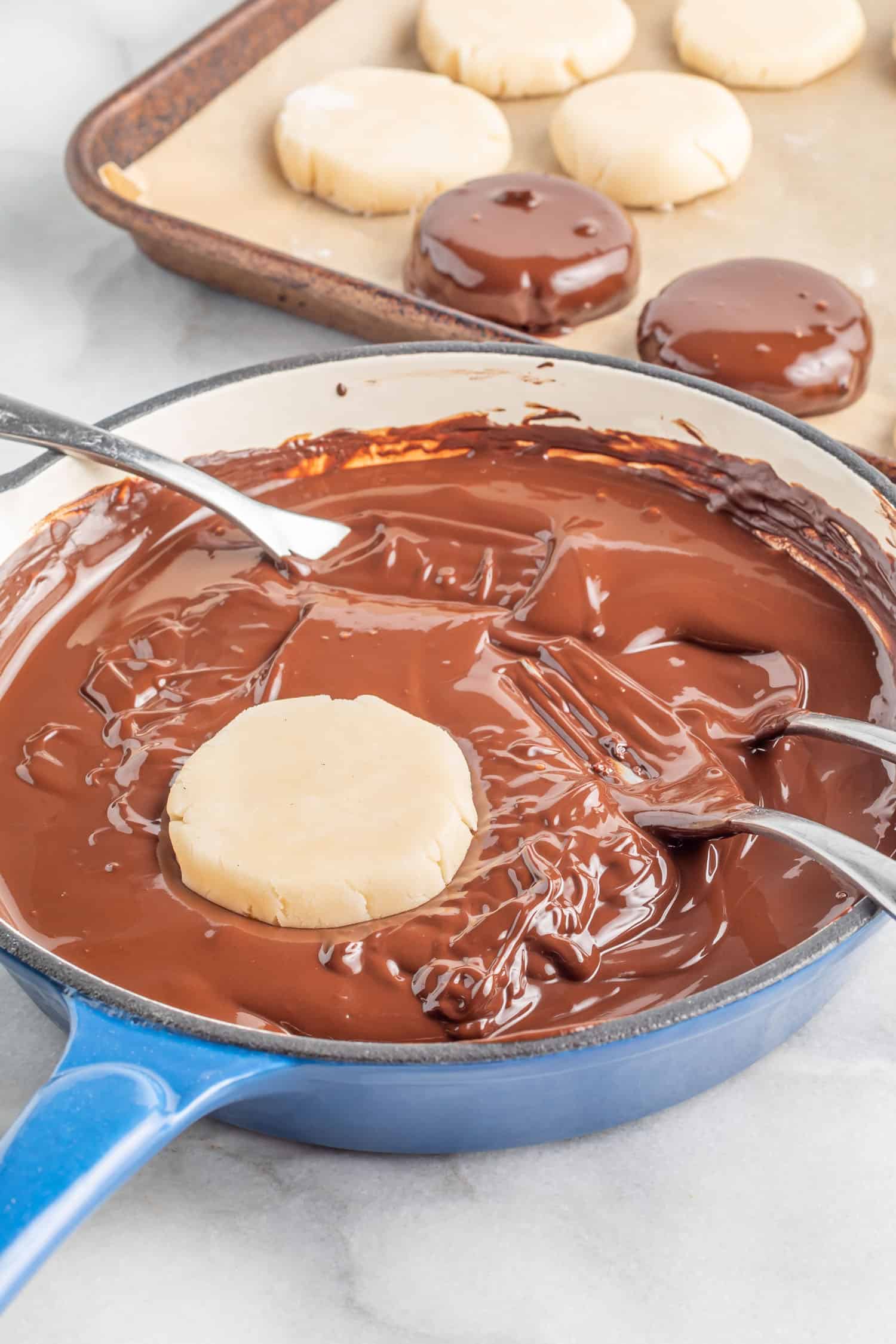 Dipping the peppermint patty dough disks into melted sugar-free chocolate