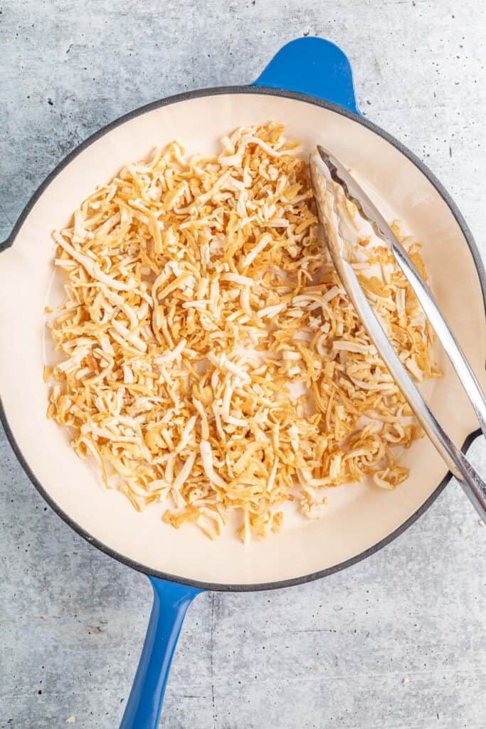 an enameled cast iron skillet filled with crispy shredded tofu