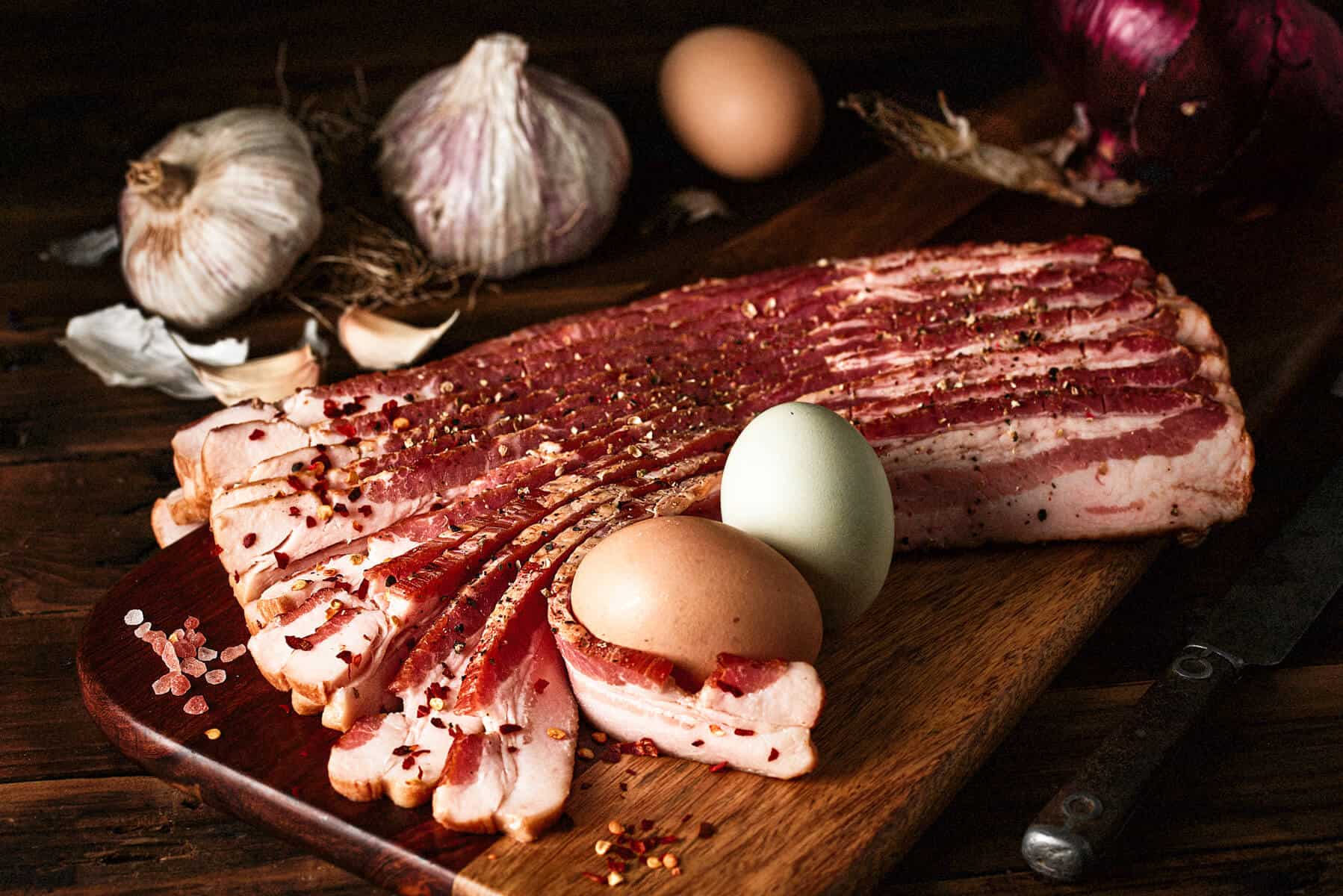 best bacon for keto on a cutting board with eggs