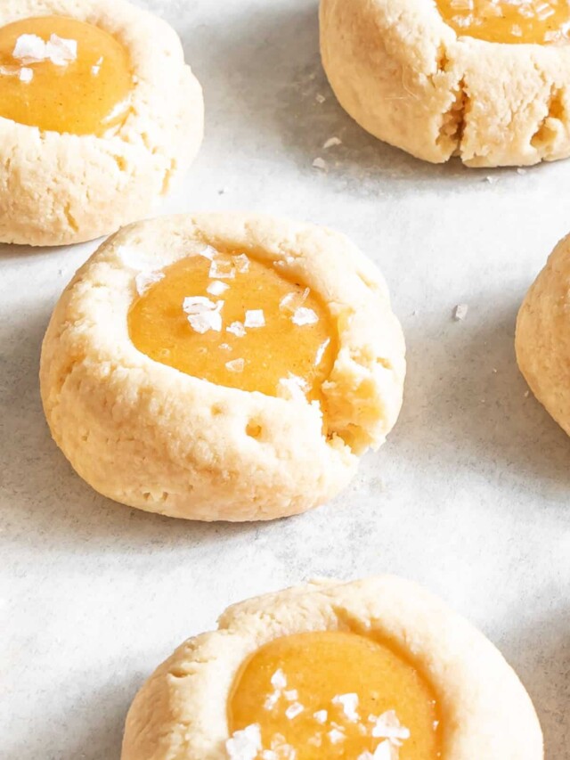 Salted Caramel Thumbprint Cookies on white parchment paper