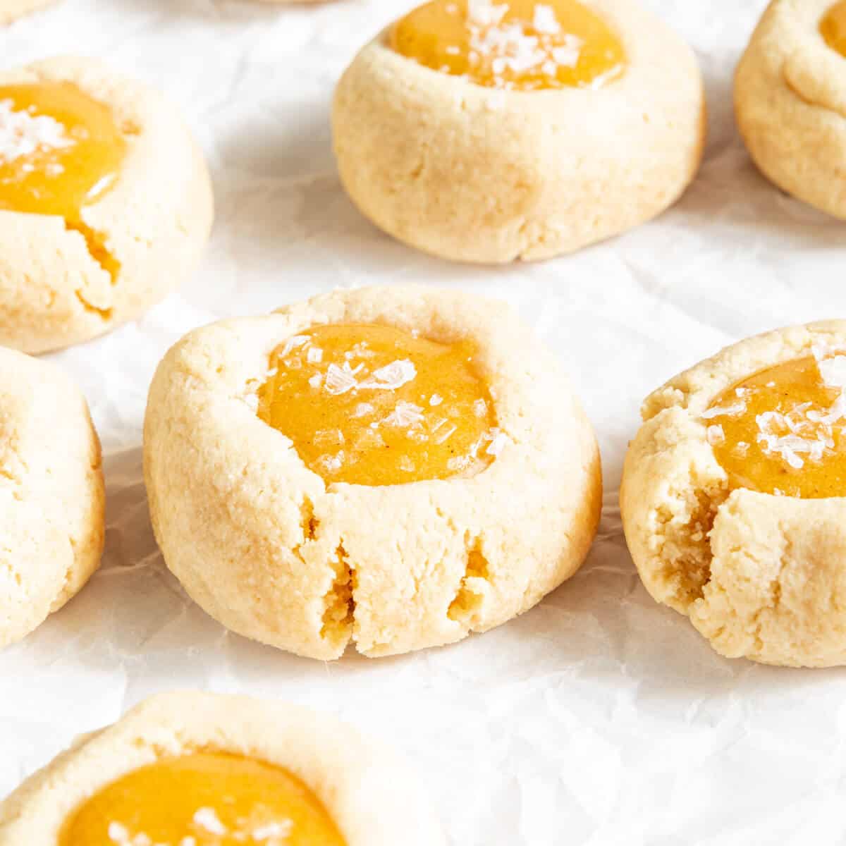 Salted Caramel Thumbprint Cookies on white parchment paper