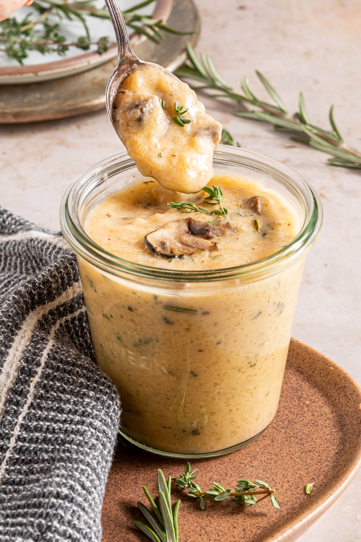 keto cream of mushroom soup in a small Weck jar with a spoon dipping some out