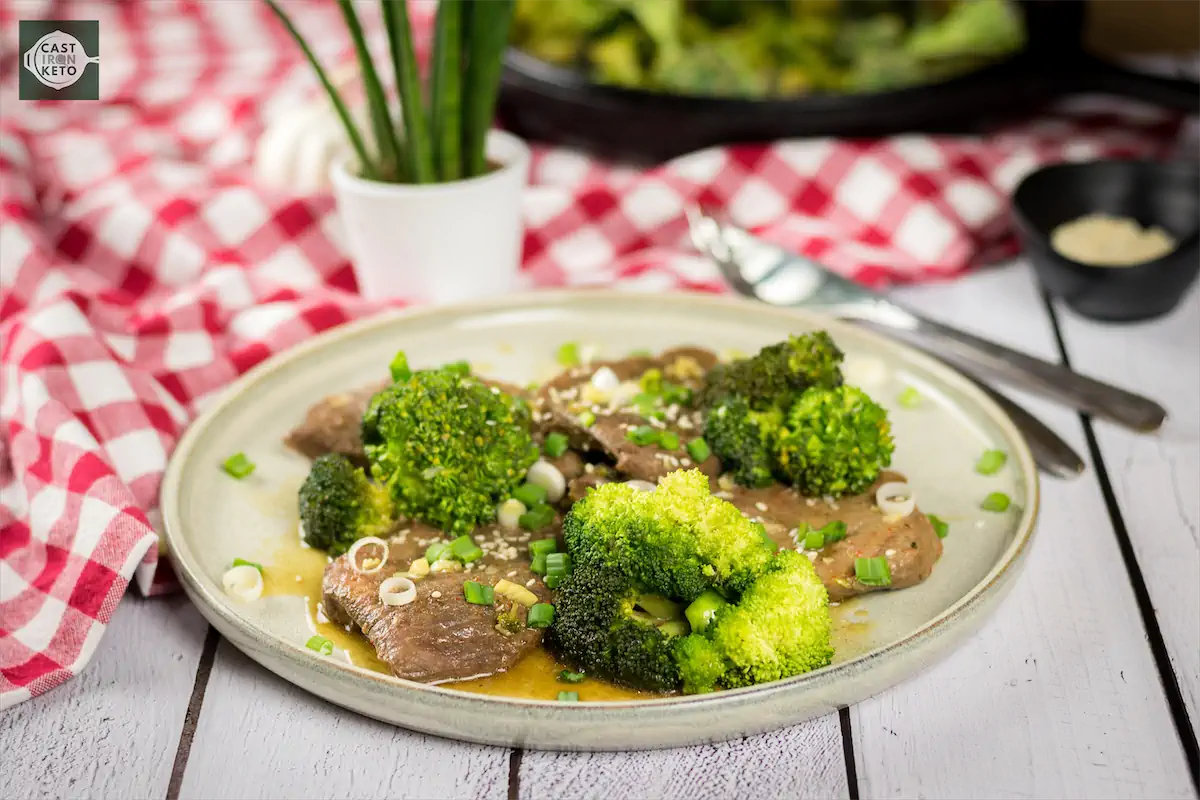 Low carb beef and broccoli dish garnished with chopped green onions.