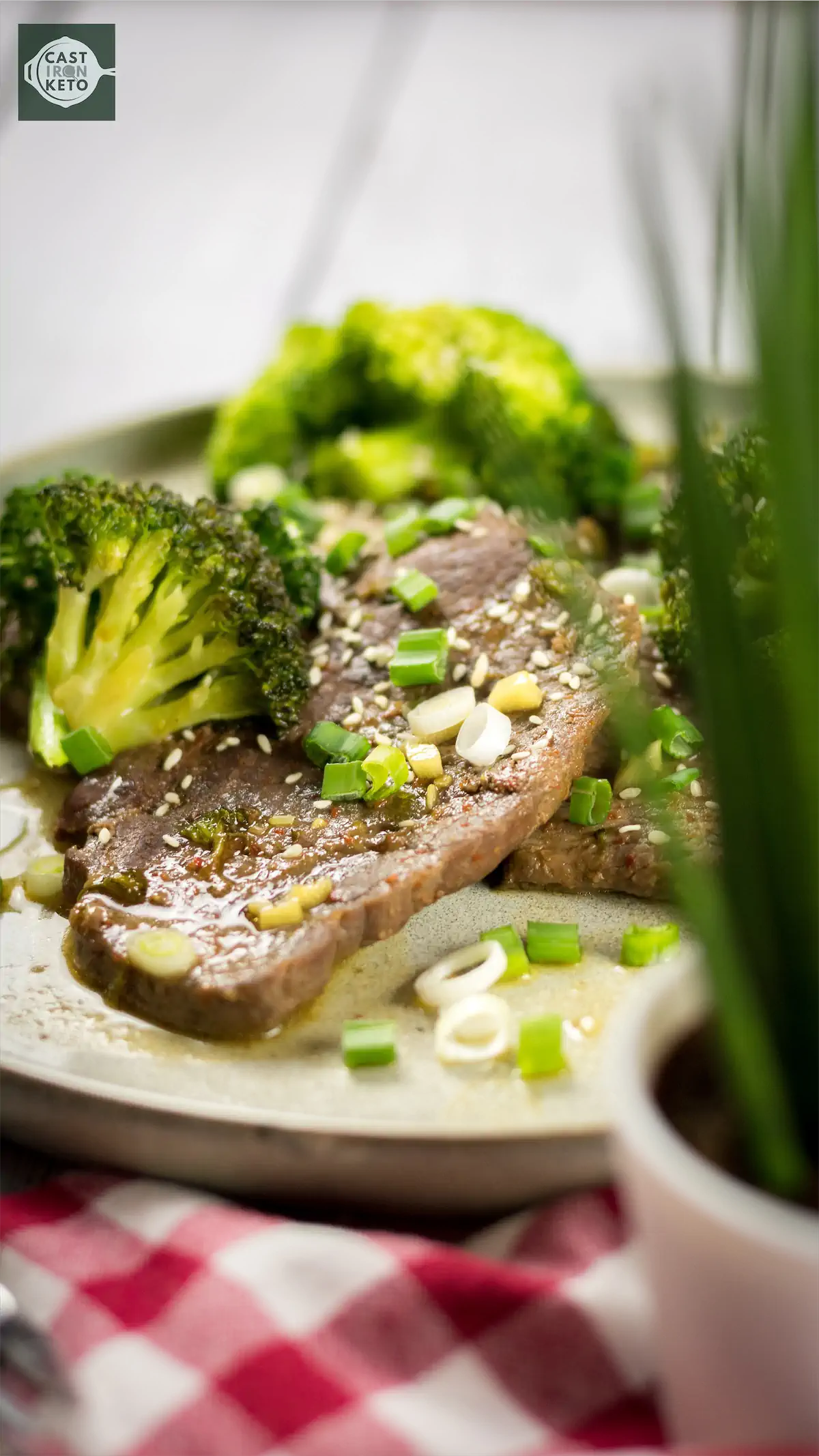 Keto-friendly beef and broccoli recipe served on a plate on a kitchen table.