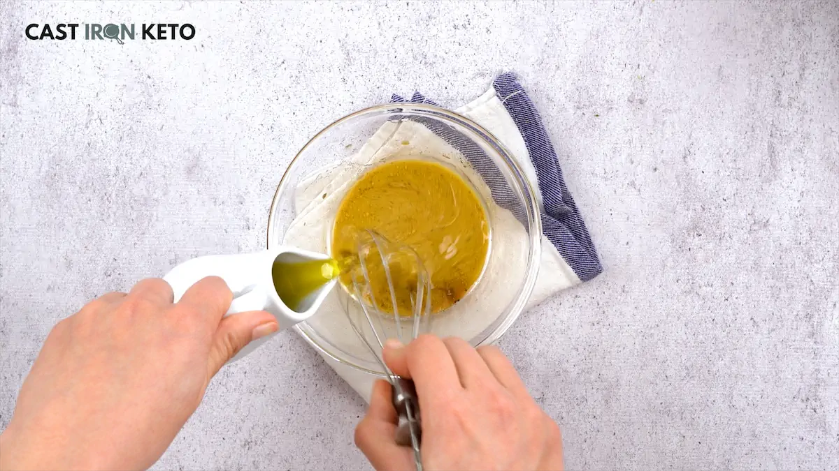 Whisking mustard, balsamic vinegar, olive oil, salt, pepper, and lemon juice in a small bowl.