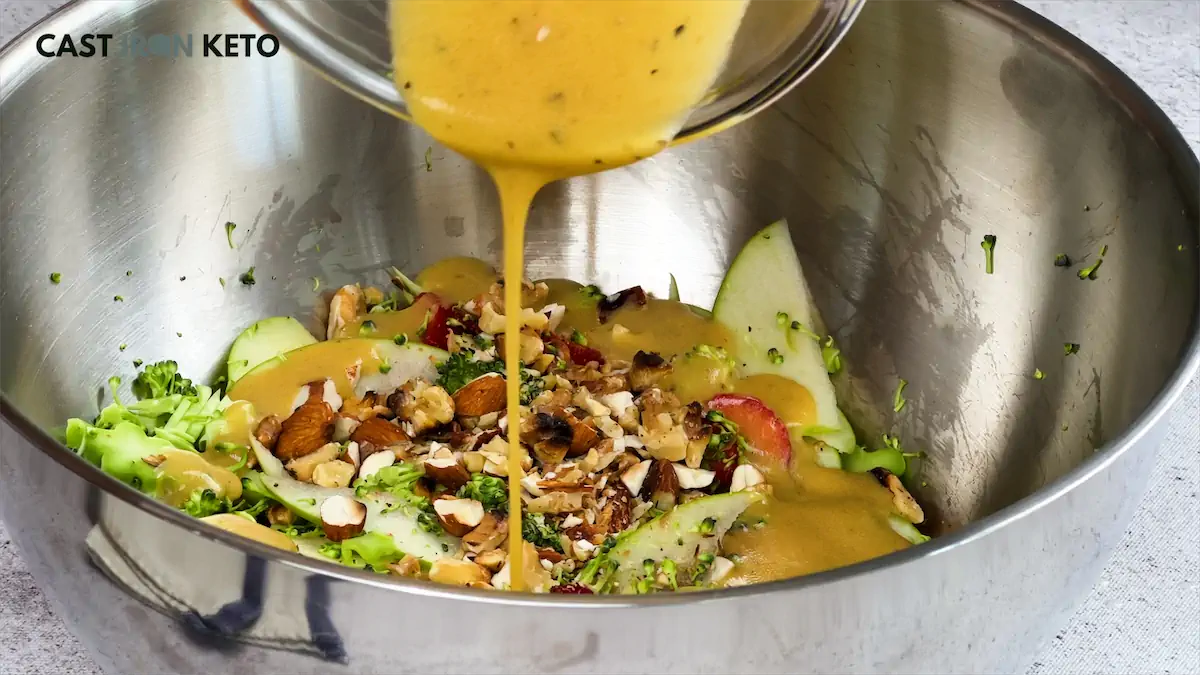 Pour the dressing over the mixing bowl with salad ingredients.