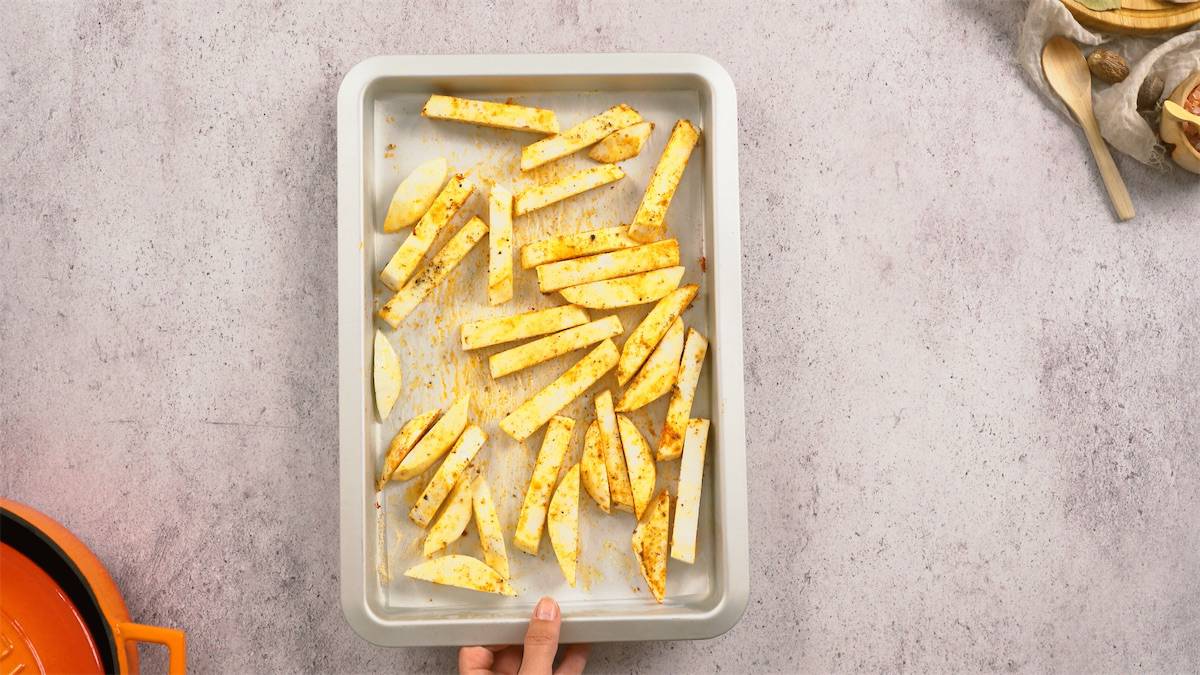 a person holding a tray of keto french fries.