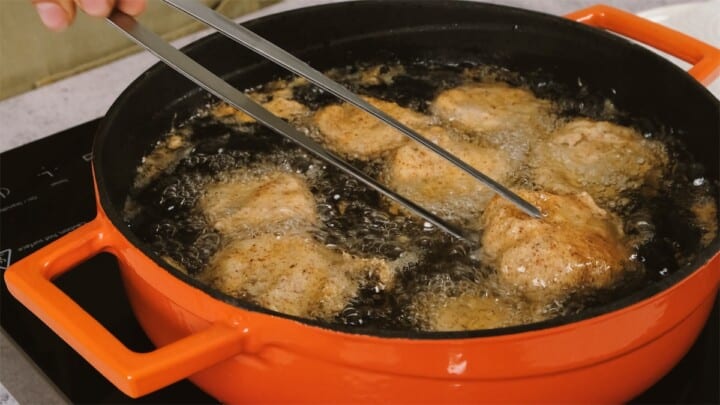a close up of a frying pan fish on a stove.