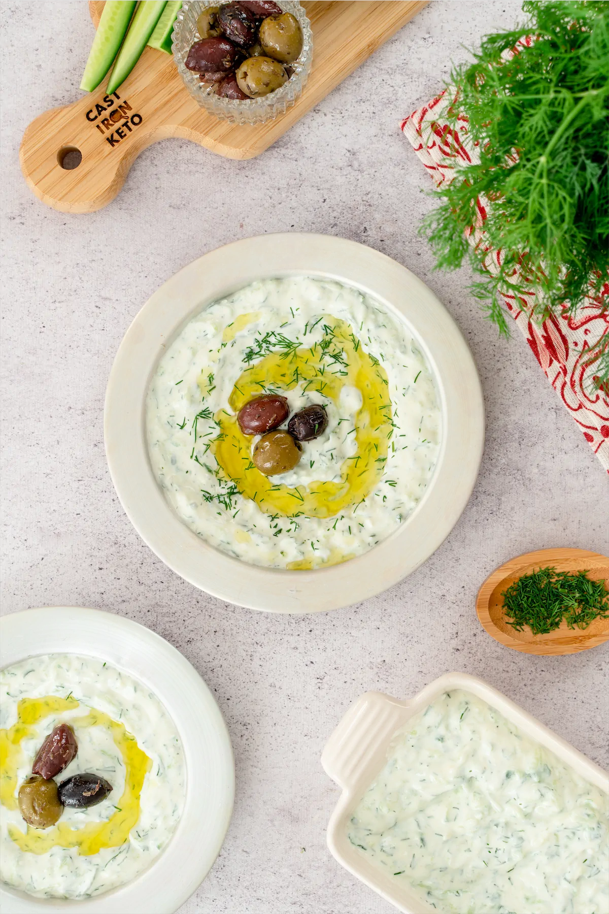 A visually appealing keto tzatziki recipe including olives, showcased on a white plate.