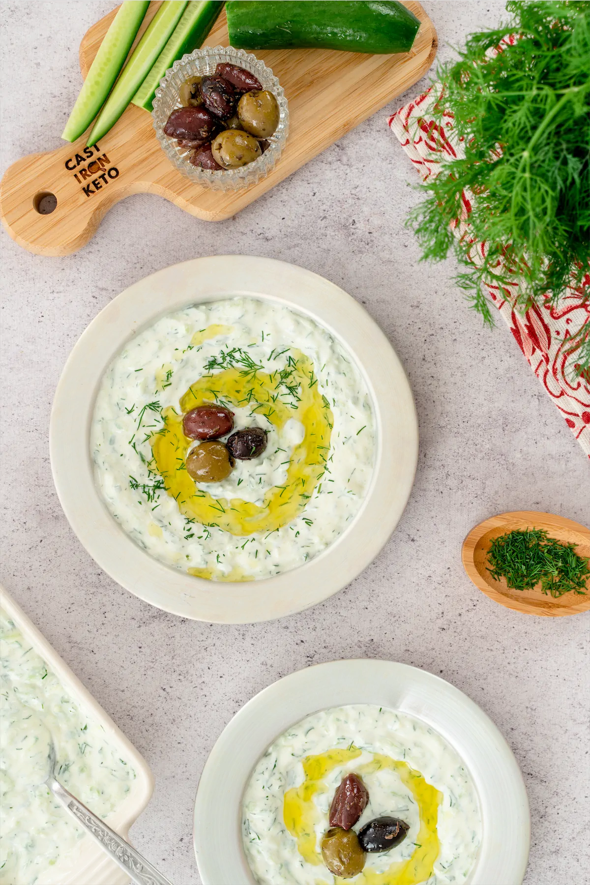 A tasty keto tzatziki recipe with olives, artfully arranged on a clean white plate
