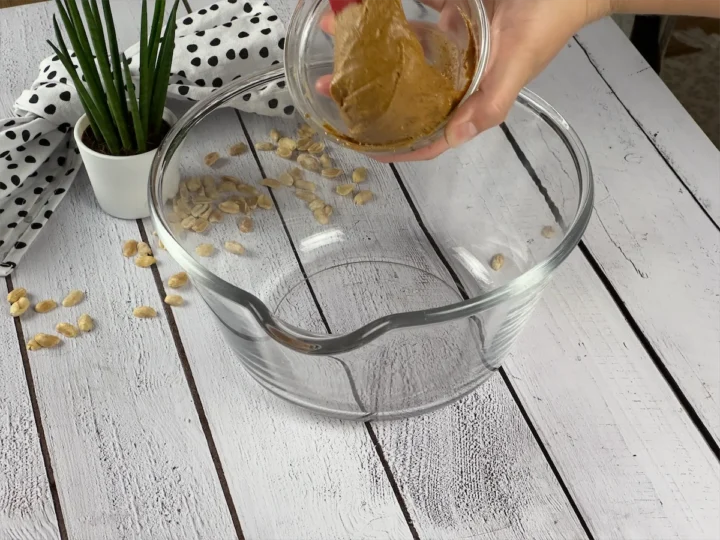 Peanut butter being transferred to a big bowl