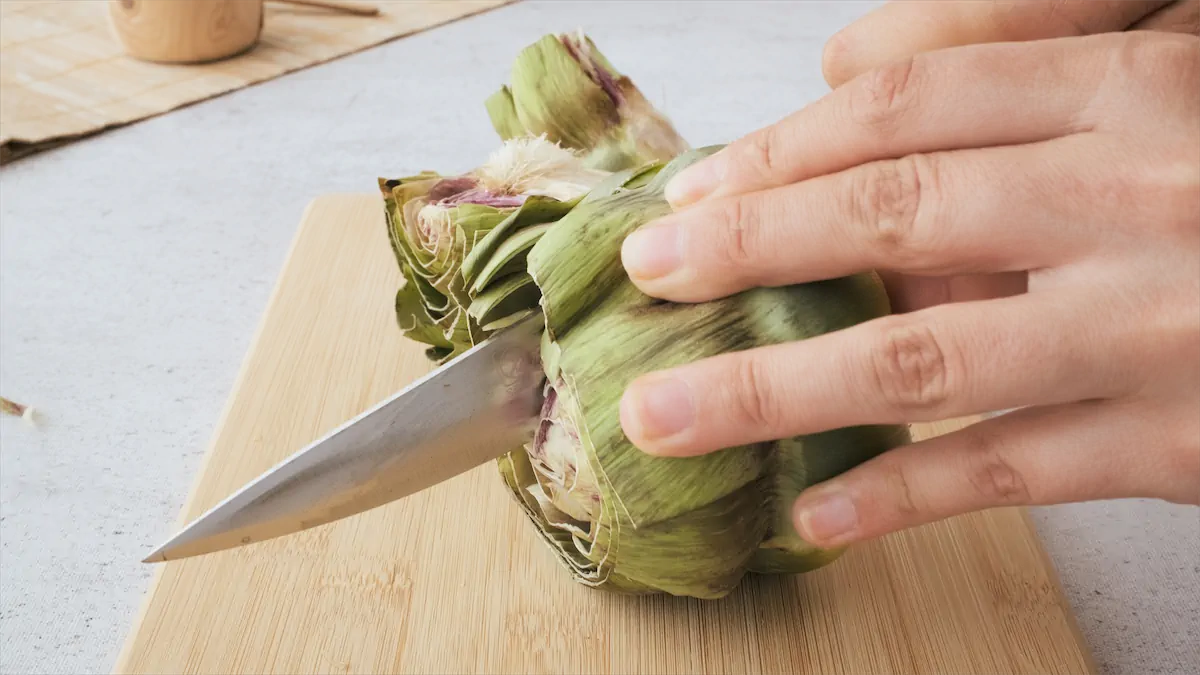 Artichoke being cut in half.