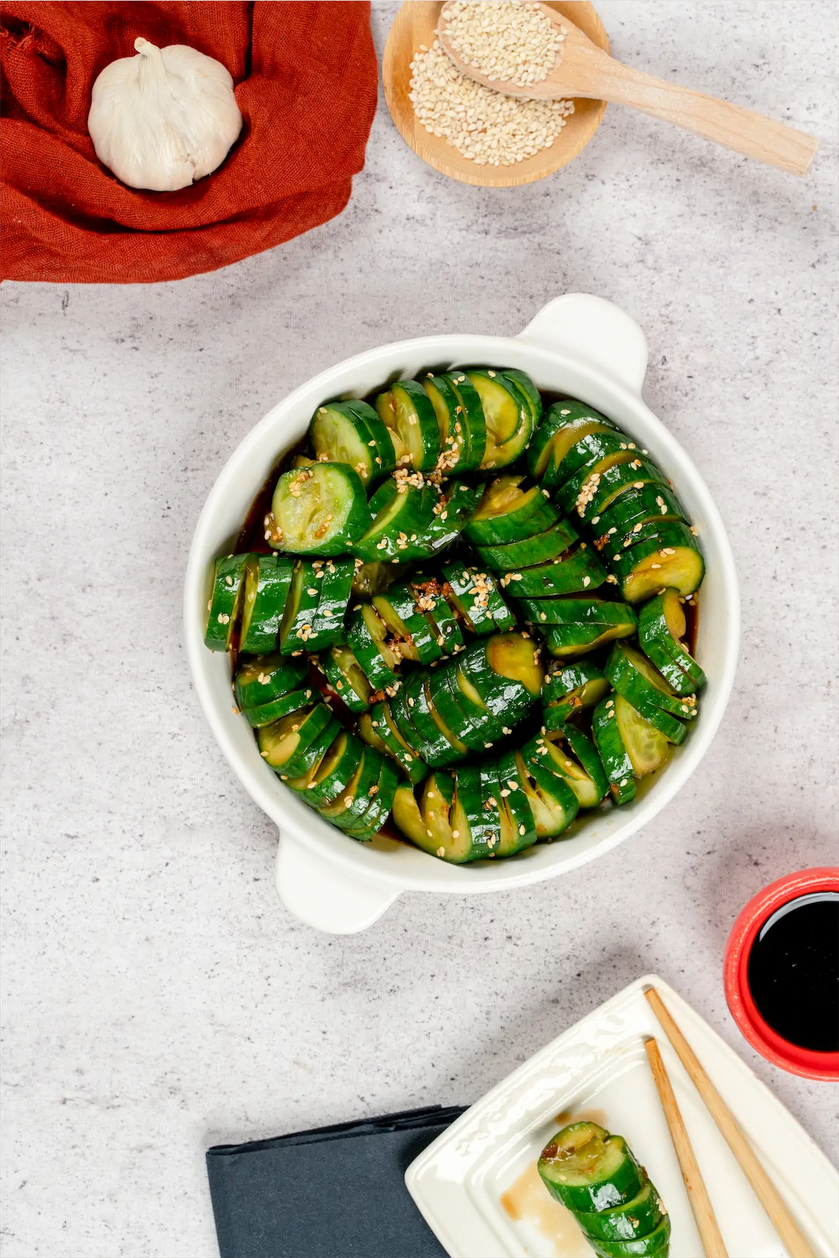 Keto asian cucumber salad served in a bowl along with chopsticks.