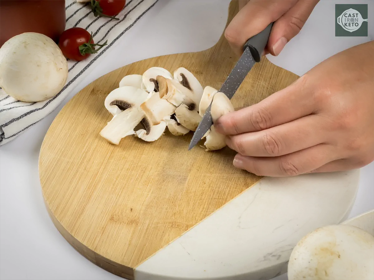 Cutting the white button mushrooms.
