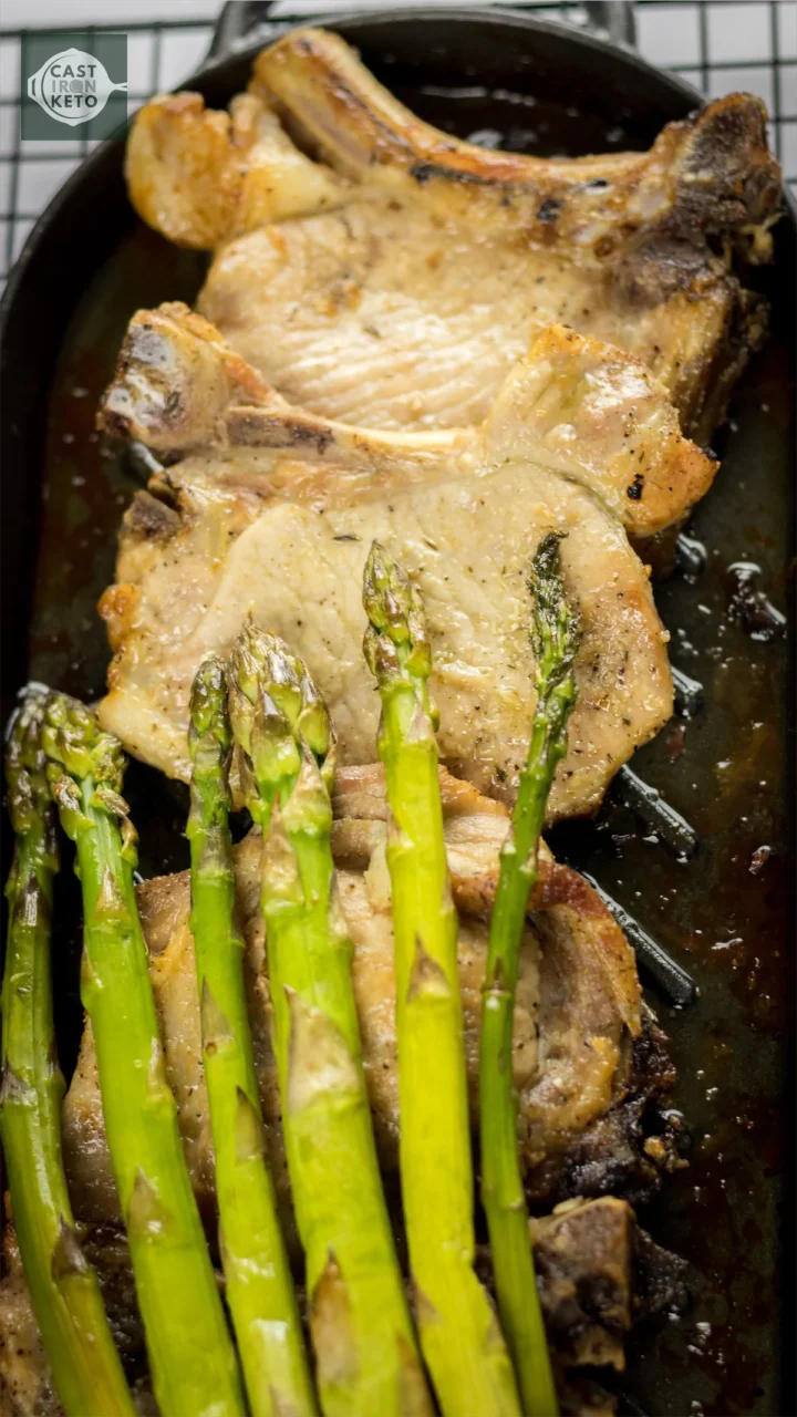 Keto baked pork recipe served with baked asparagus.