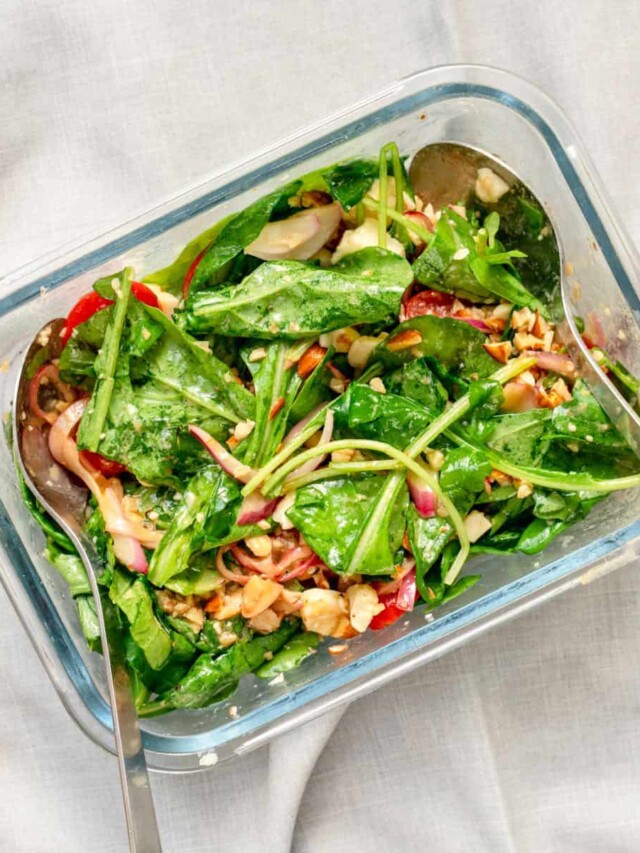 Keto Arugula Salad with Balsamic Vinaigrette prepared in a glass mixing bowl.