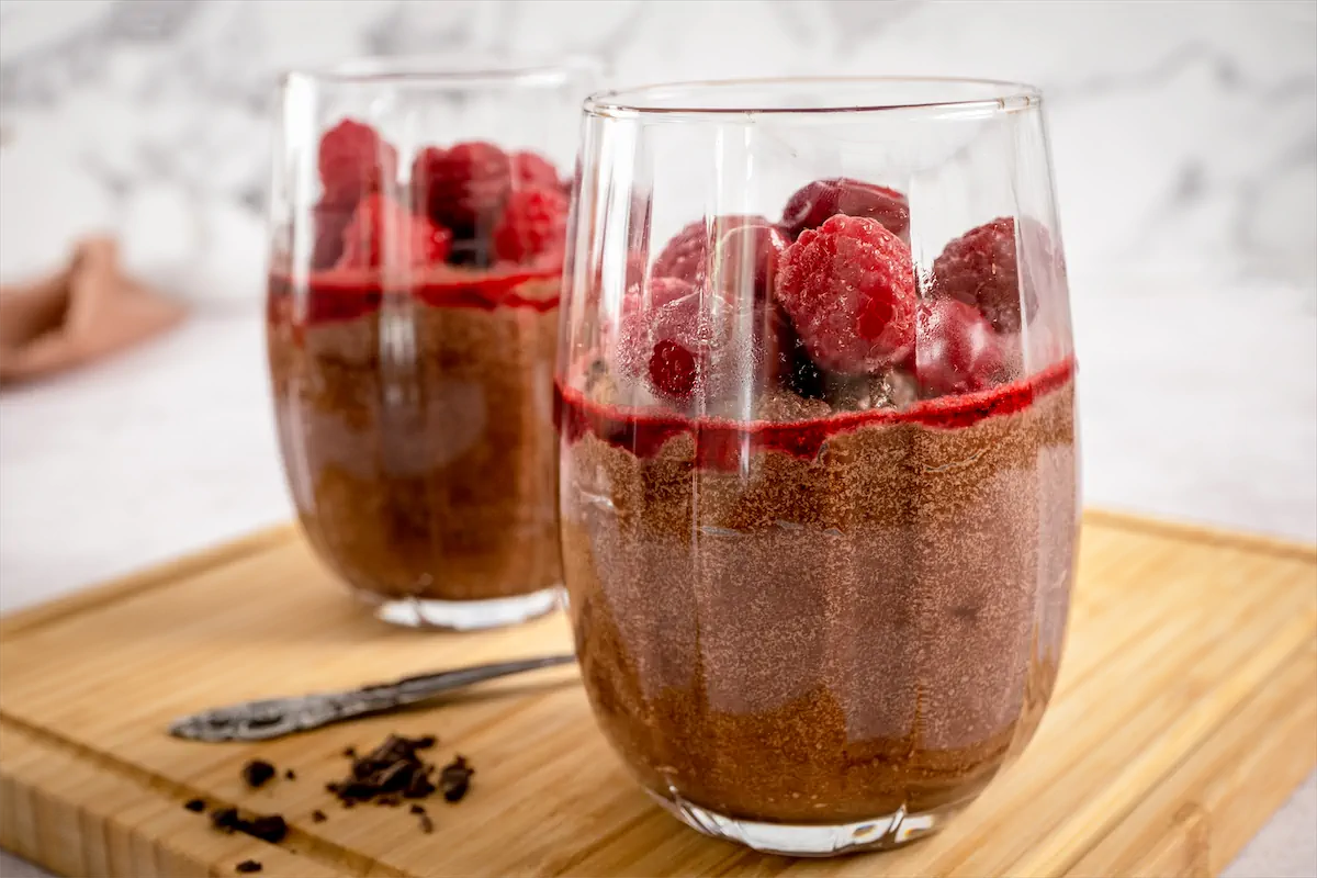 Keto mousse recipe topped with cherries and berries.