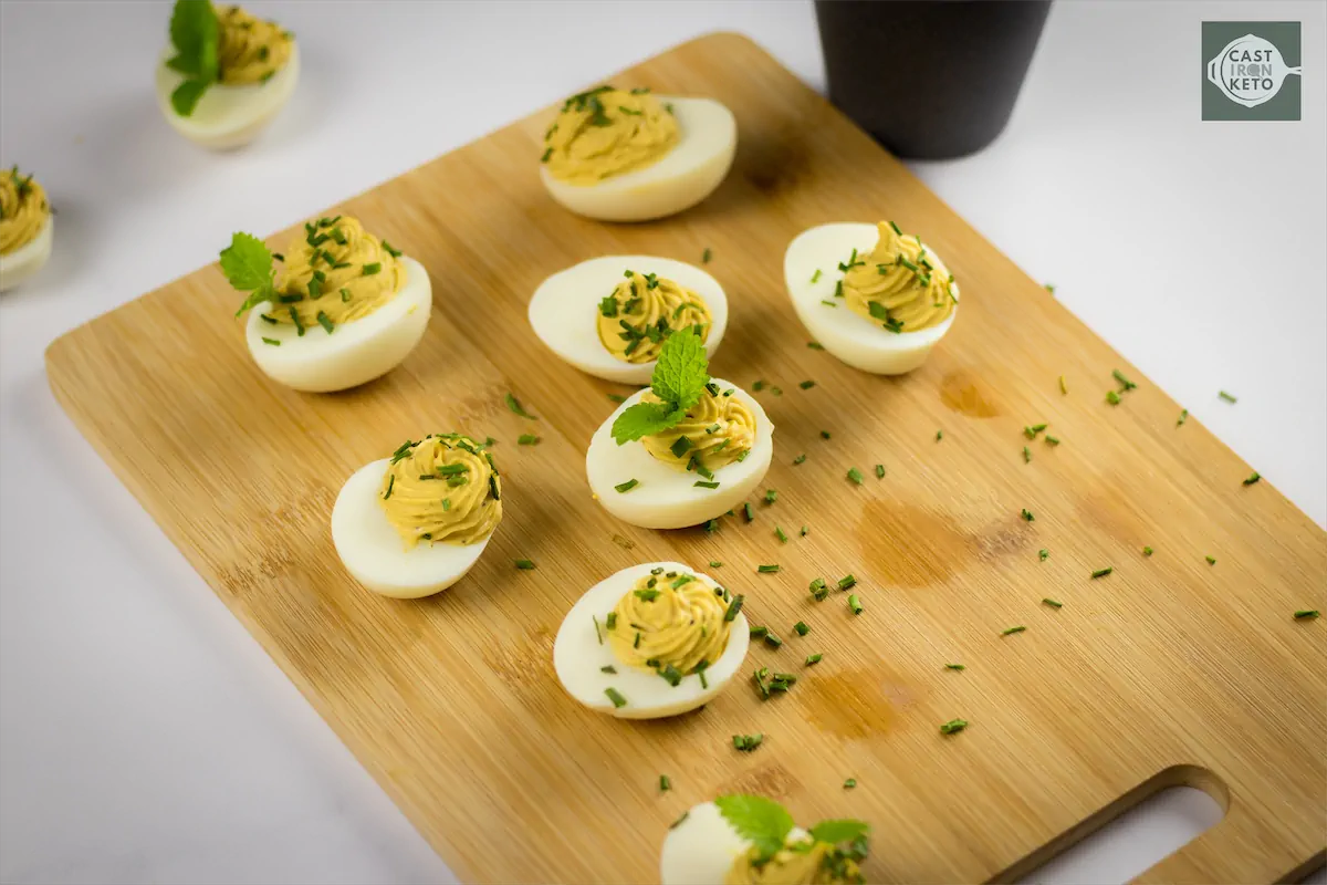 A batch of keto deviled eggs recipe on cutting board.