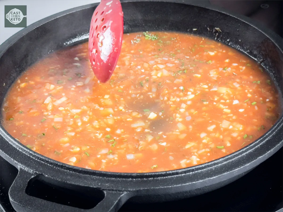 Preparation of sauce in a cast iron dish.