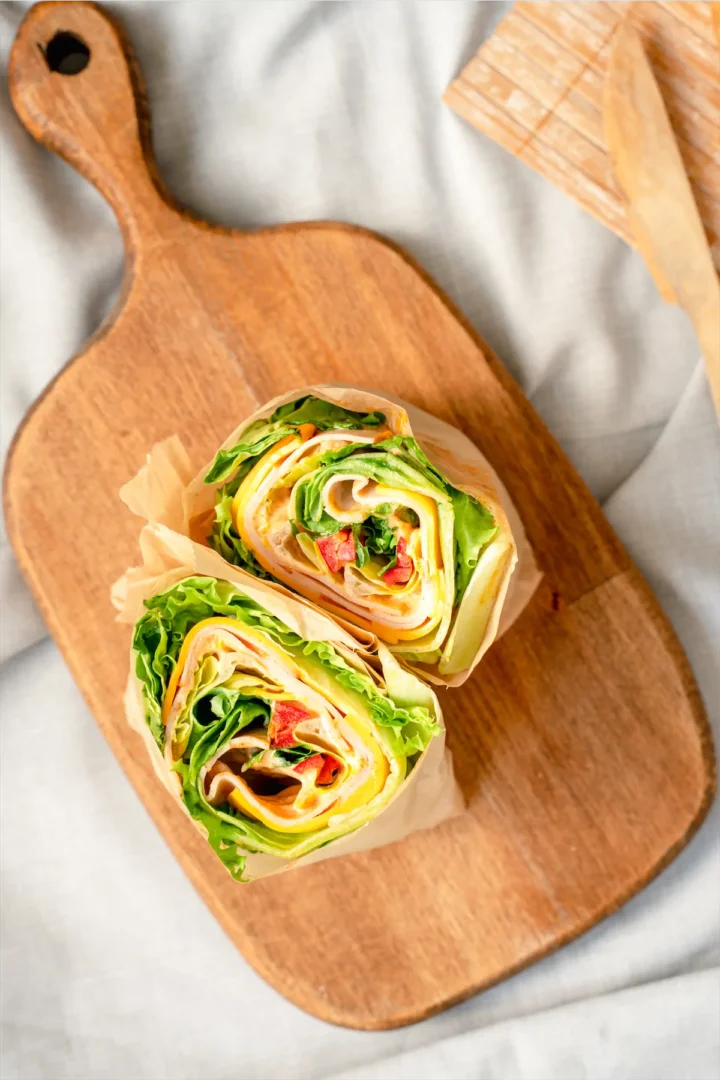 Keto lettuce wraps sliced into two pieces.