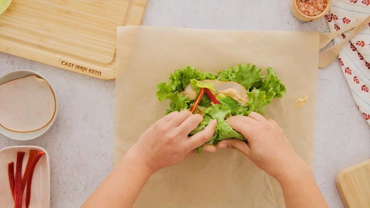 Rolling the ingredients inside lettuce leaves.