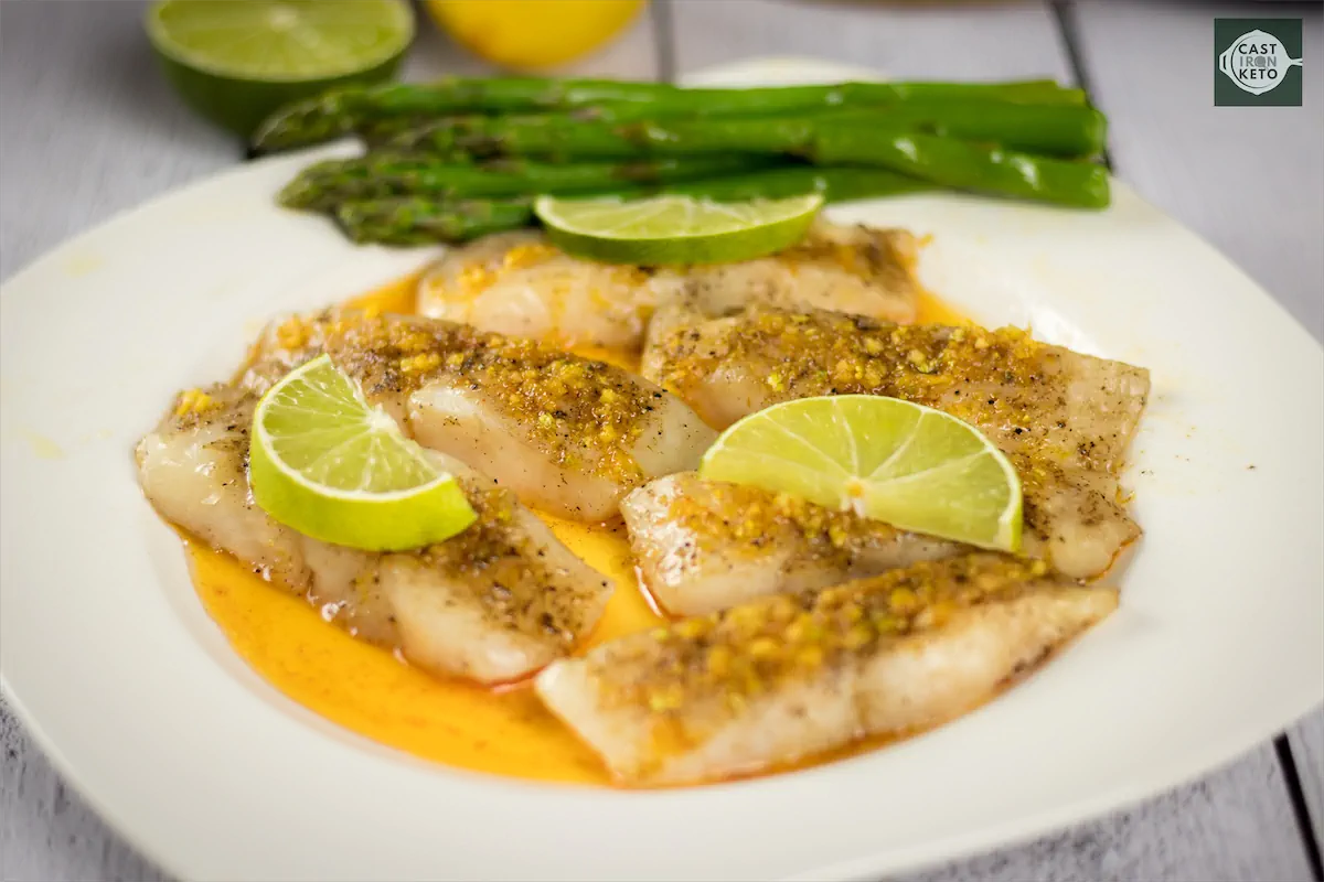 Mahi mahi recipe topped with lime slices on kitchen table.