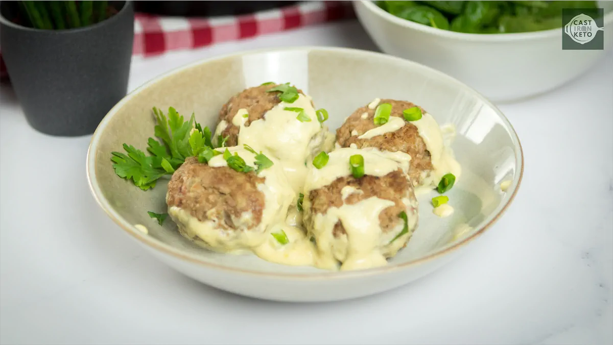 Low-carb meatballs with cheese sauce topping.
