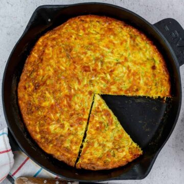 Baked keto zucchini frittata recipe in a cast iron pan, ready to be served.