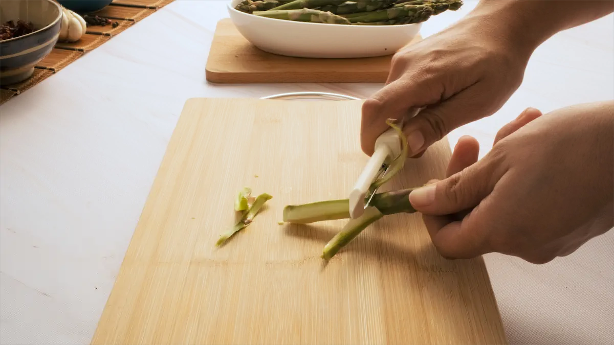 Peeling asparagus using a peeler.