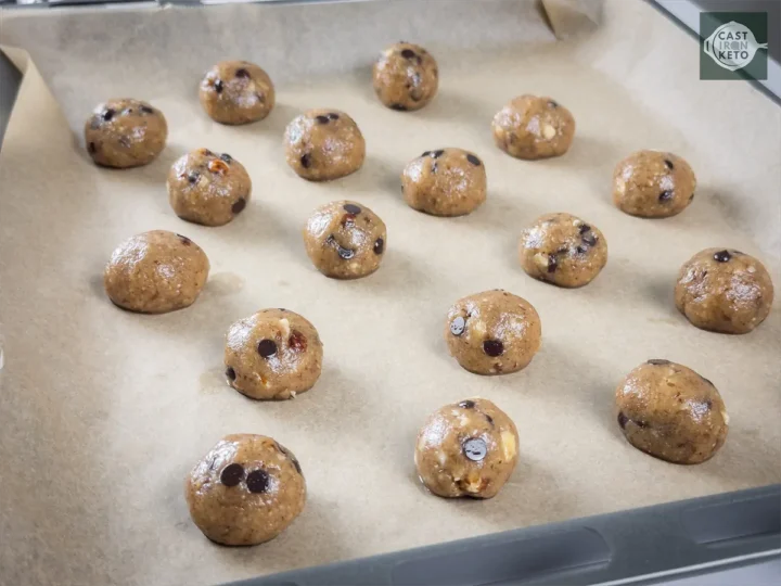 Small balls of keto cookie dough containing chocolate chips.