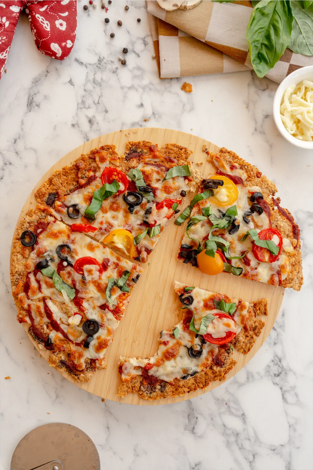 Pizza on pizza board, one slice half eaten.