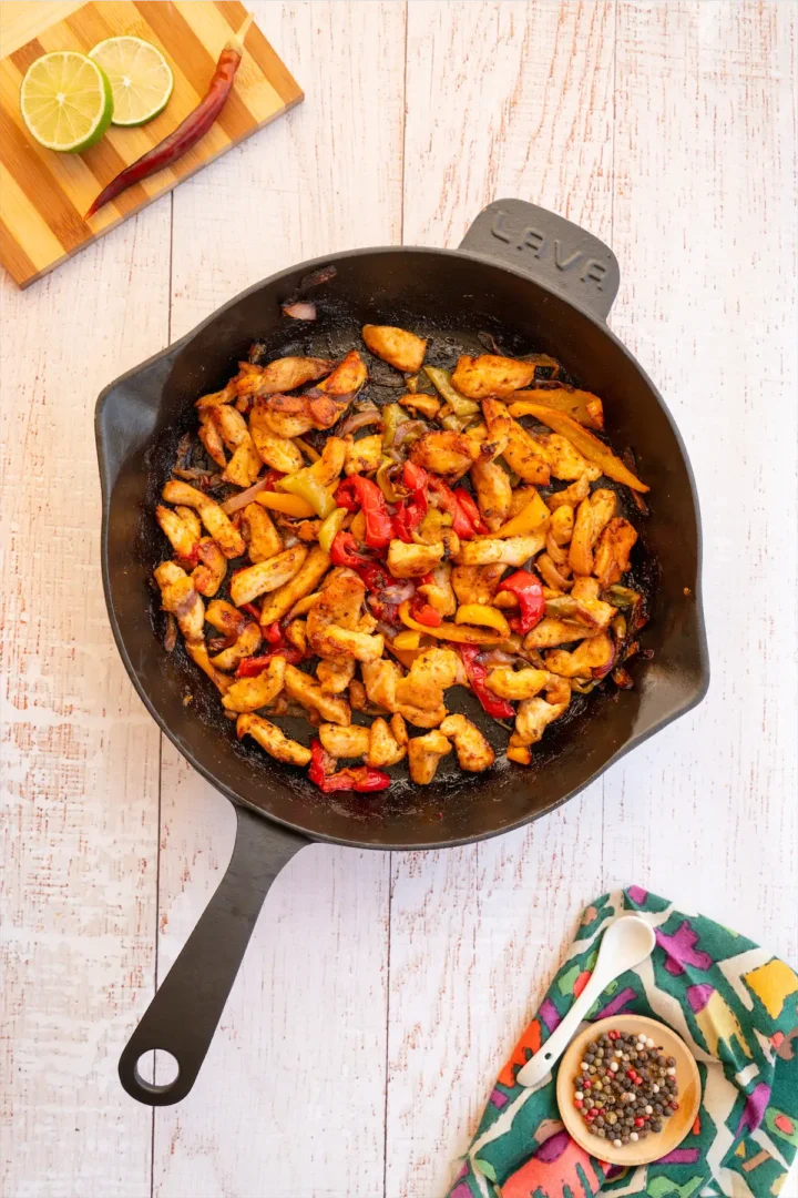 Low-carb fajitas cooked in a cast iron pan.