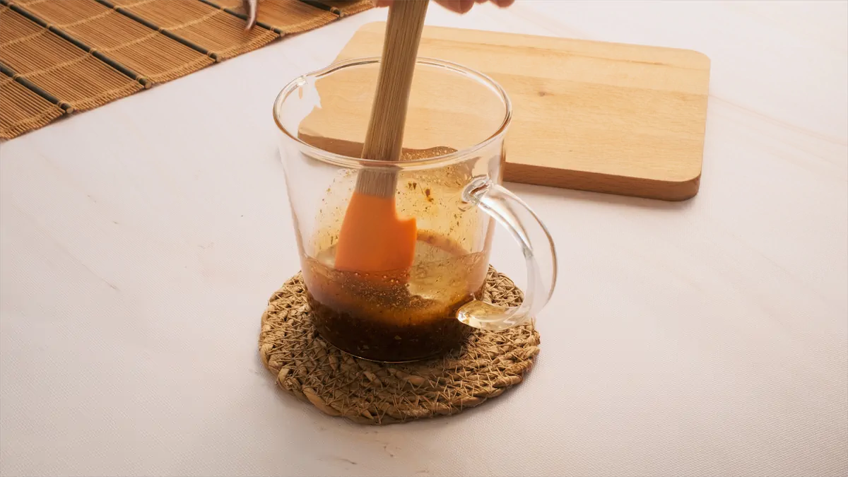 Mixing the spices with olive oil in a cup.