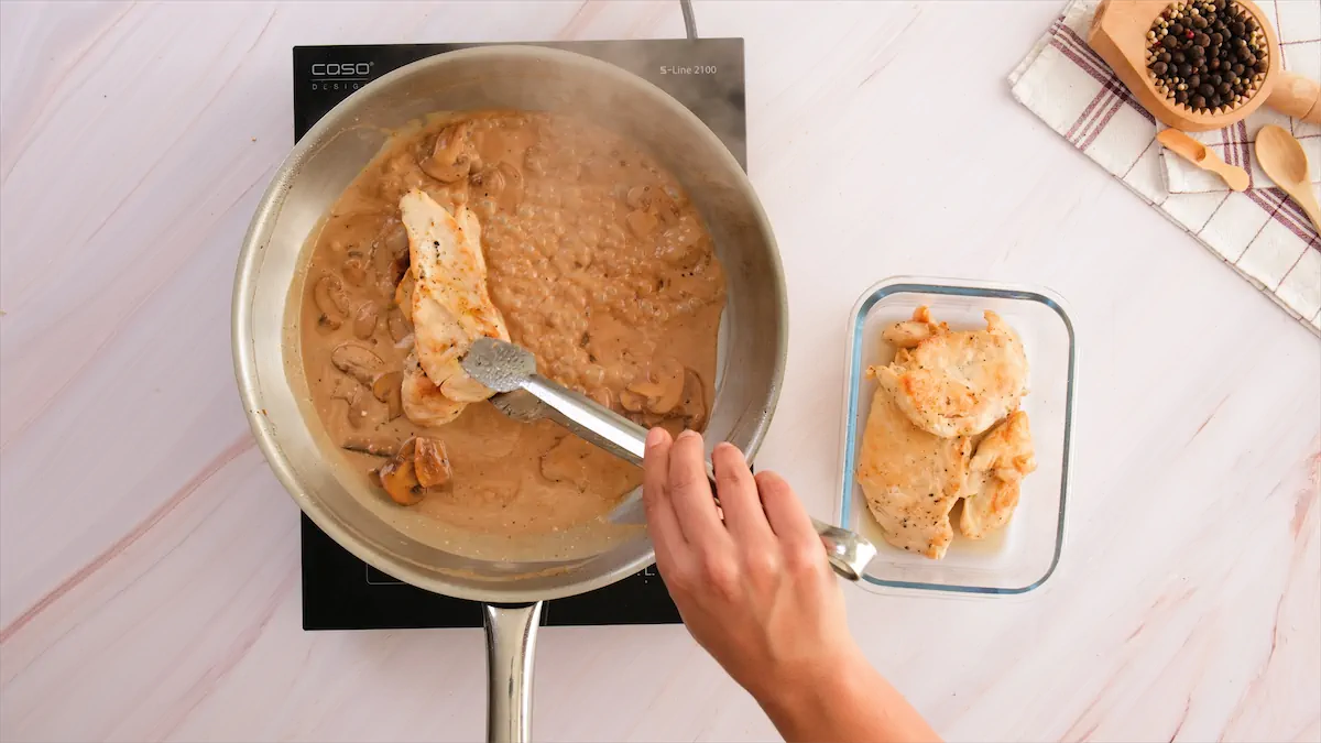Adding chicken slice to the pan.