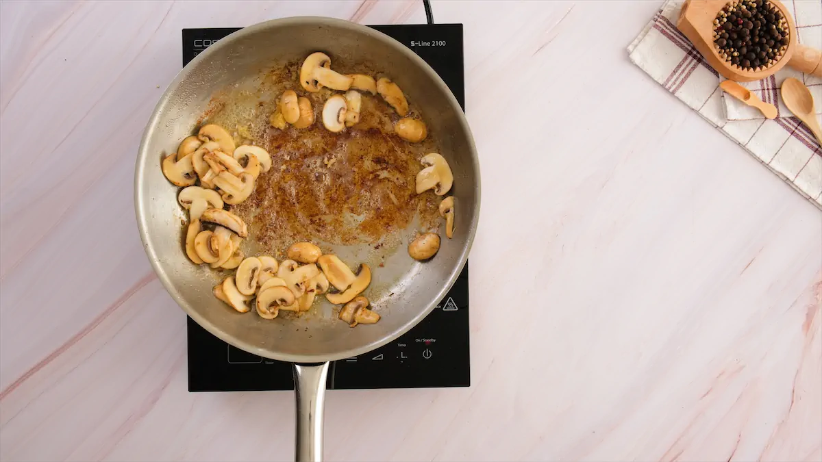 Frying mushrooms in a pan.