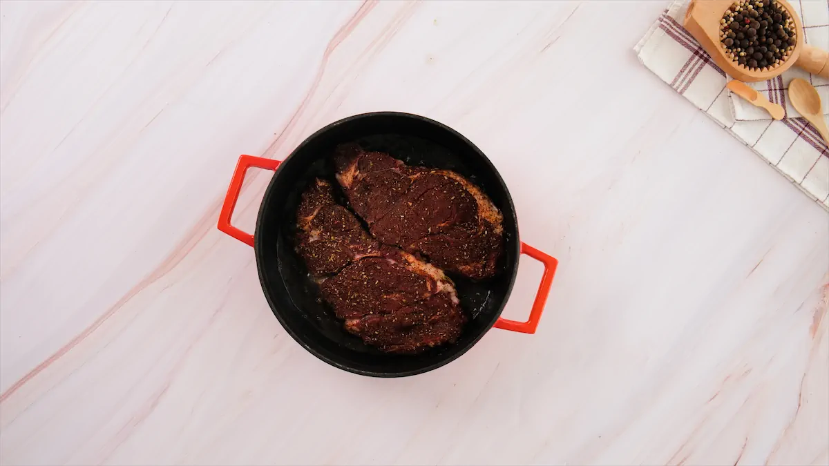 Cooking the beef slices in a cast iron skillet.