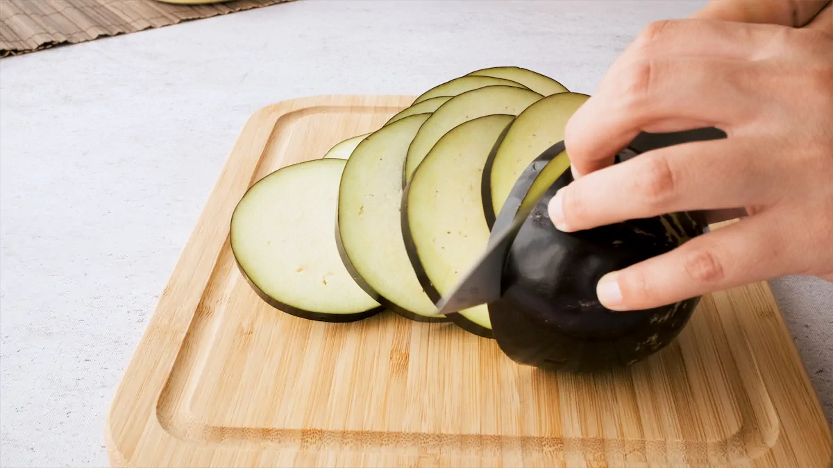 Slicing eggplant into thick rounds.