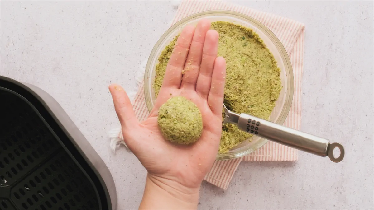 Uncooked falafel ball in a hand.