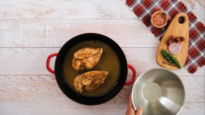 Cooked chicken breasts in a skillet.