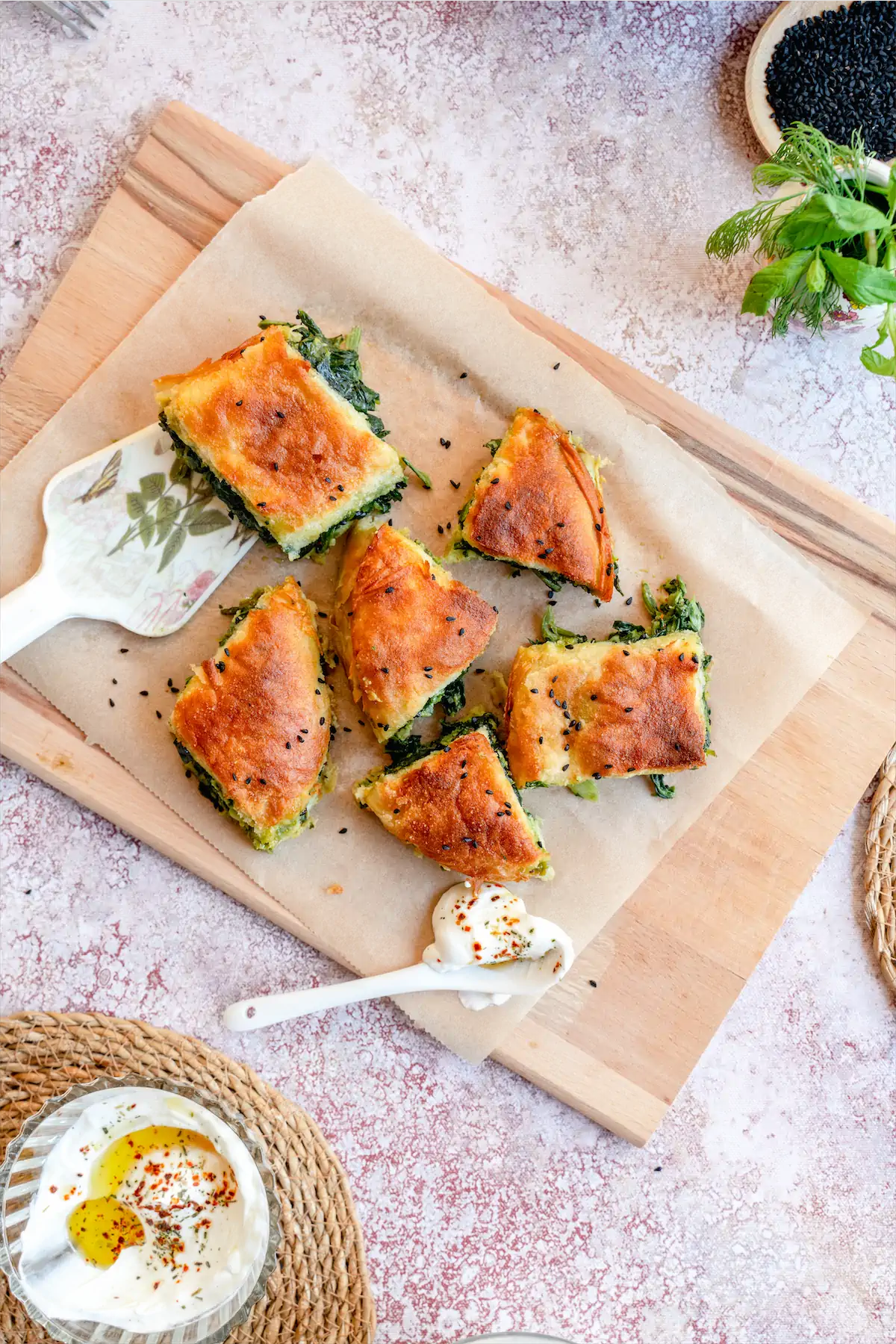 Slices of homemade Spanakopita recipe on parchment paper.