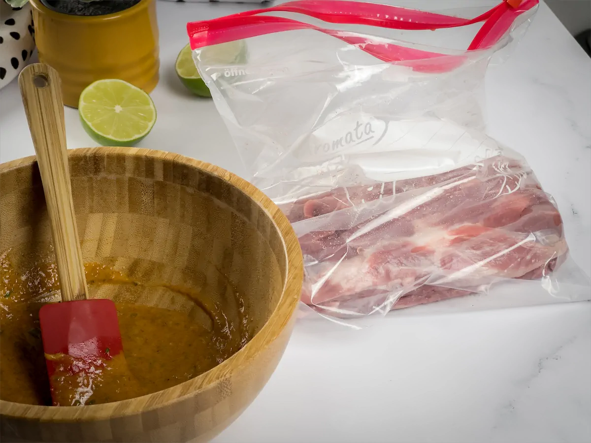 Sealing steak slice and marinade in a zip lock bag.