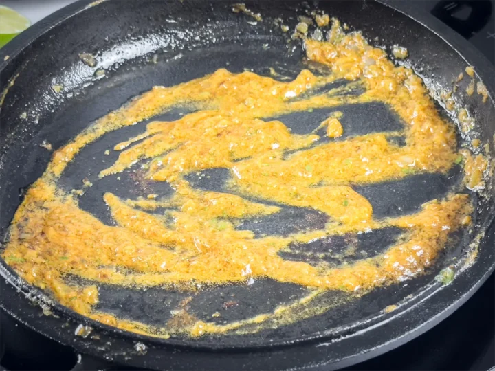 Heating the reserved steak marinade in a skillet.