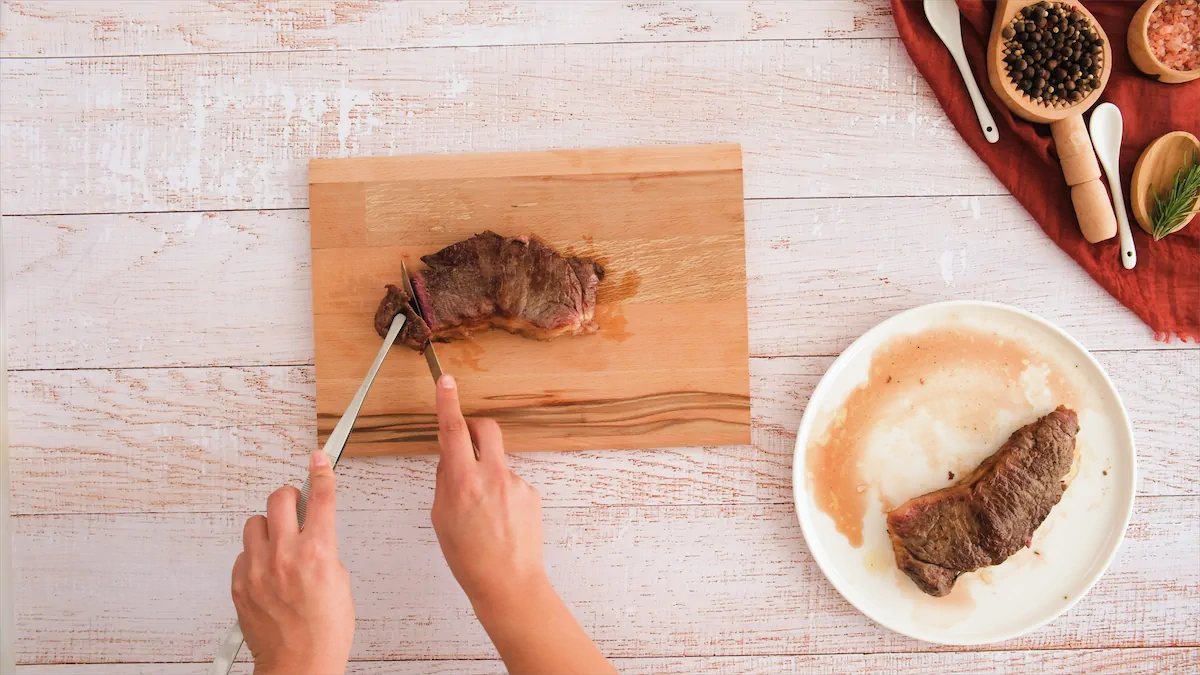 Slicing steak with a knife.