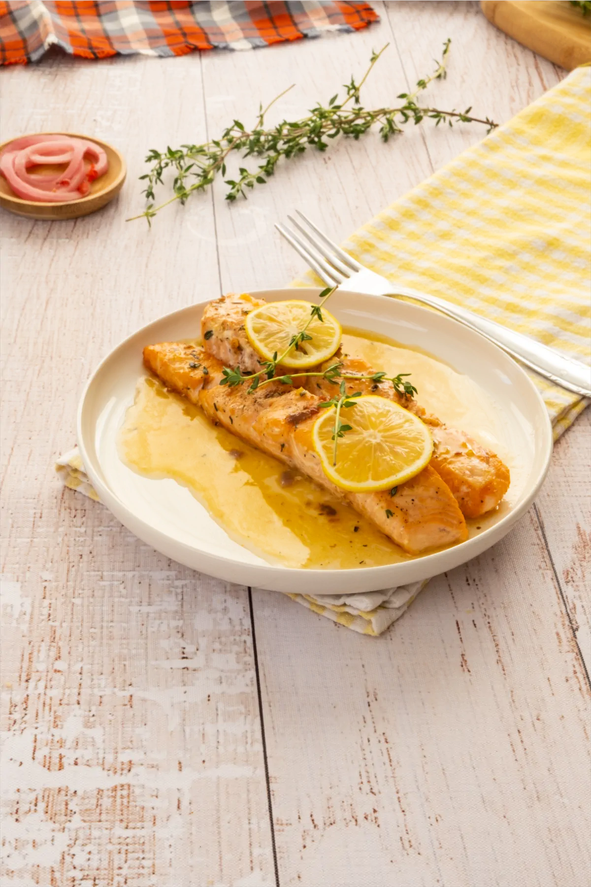 Salmon recipe with lemon butter sauce served on a plate.