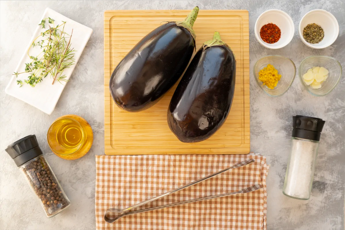 Ingredients spread out to prepare roasted eggplant recipe.