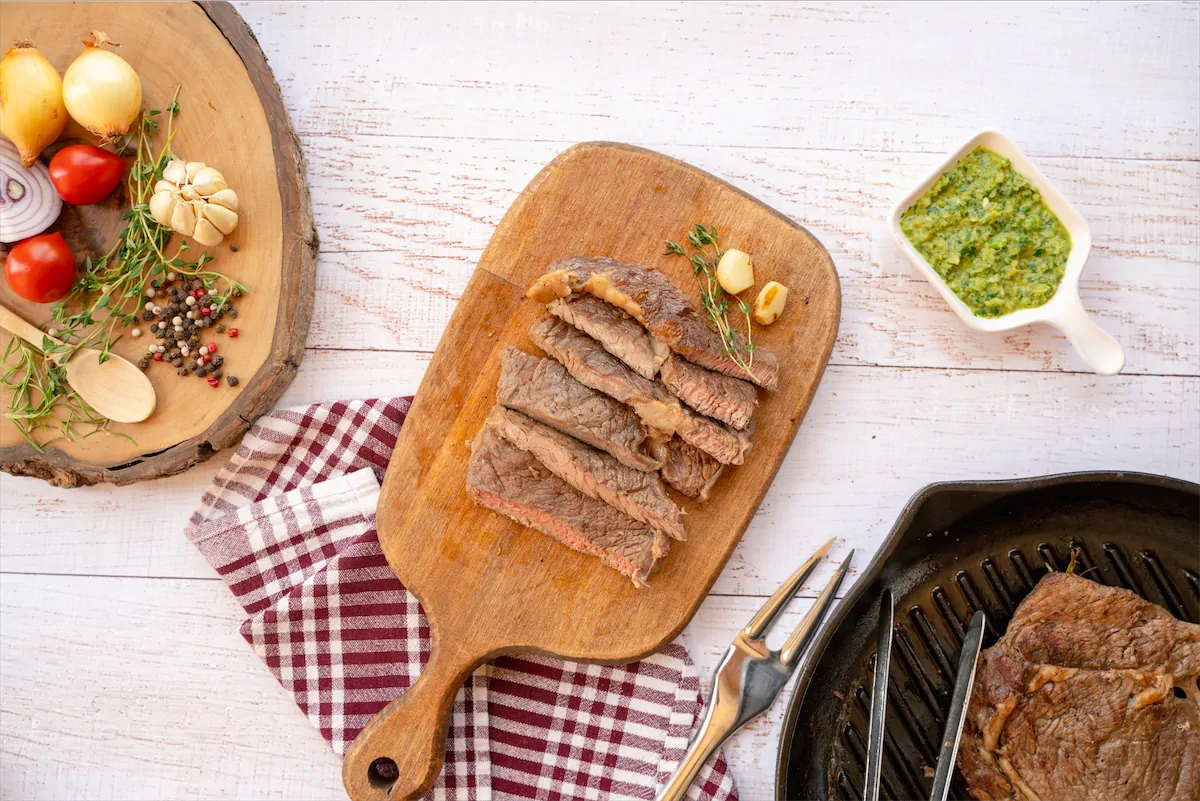 Sirloin steak slices served on a wooden serving board.