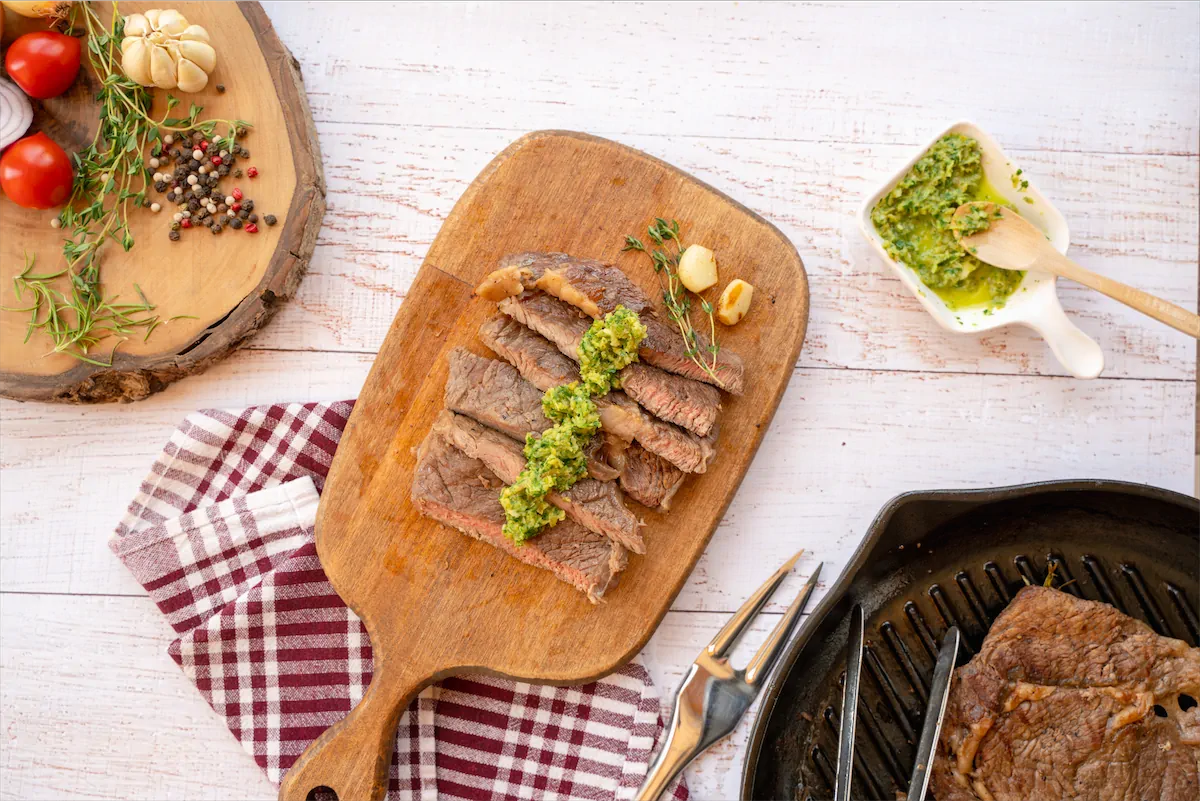 Sirloin steak slices topped with sauce.