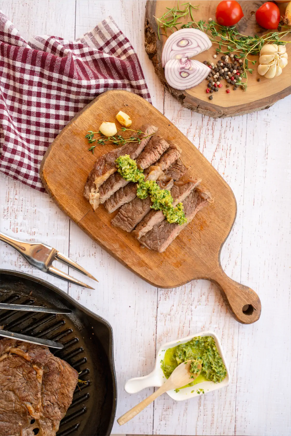 Low carb steak recipe served on a wooden board, topped with sauce.