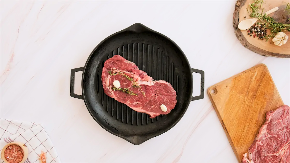 Grilling the steak on a cast iron grill pan.