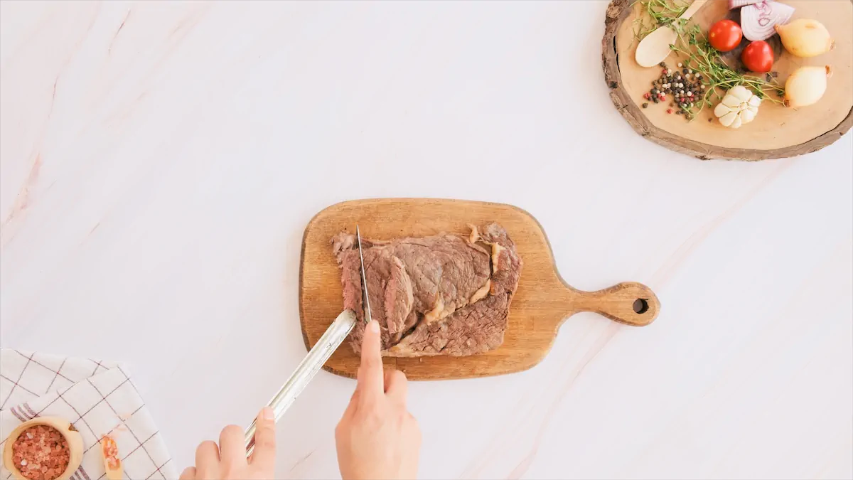 Slicing the steak into thin strips.
